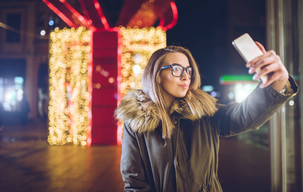 istock Woman making selfies downtown at night 1092847714