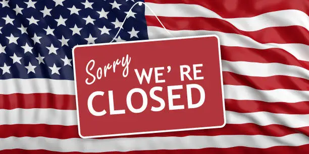 US government shutdown. Sorry we re closed sign on waving US flag background. 3d illustration