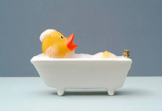 giant rubber duck taking a bath. grey background