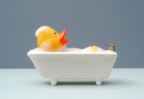rubber duck relaxing in the bath - bath toy imagens e fotografias de stock