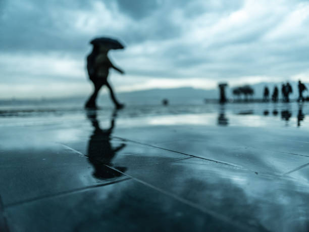istock People walking under the rain in the rainy day 1092859364