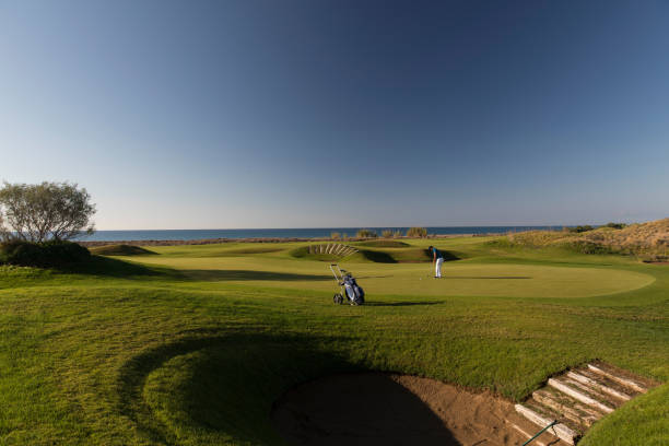istock Links golf area wide angle photo while golf player shooting 1092865450