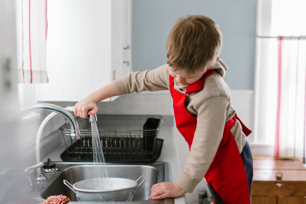 istock Child cooking and baking in kitchen at home 1092866464