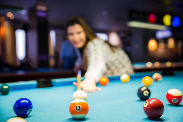 istock Woman Playing Pool ready to hit Ball 1092869252