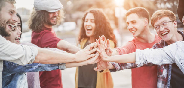 istock Young millennials friends stacking hands together - Happy students celebrating together - Youth lifestyle, university, social trends, relationship and friendship concept - Focus on hands 1092870014