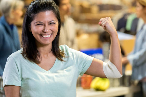 istock Woman flexes arm after donating blood 1092875746