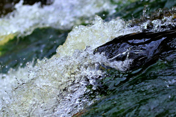 Super Close Up Fast Moving Eno Close up fast moving water over rocks in eno river eno river stock pictures, royalty-free photos & images