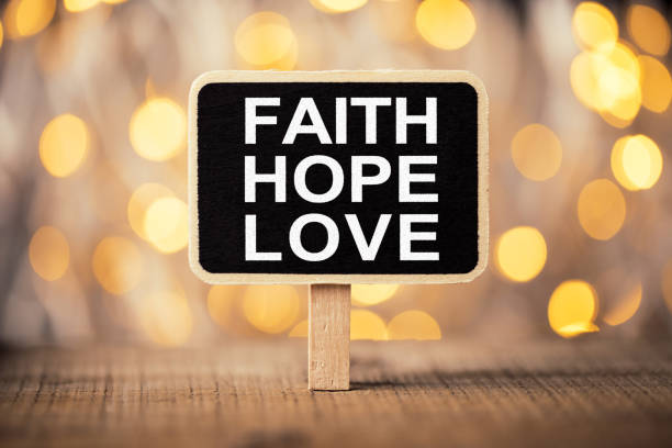 Faith Hope And Love blackboard against beautiful shiny background.