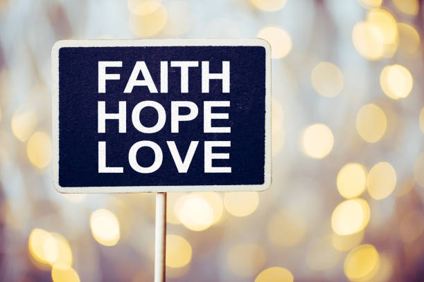 Faith Hope And Love blackboard against beautiful shiny background.