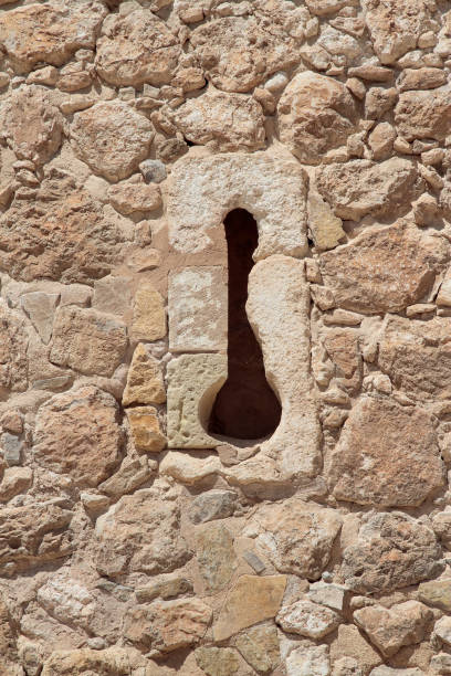 istock arrow slit in the stone wall of a castle 1092905514