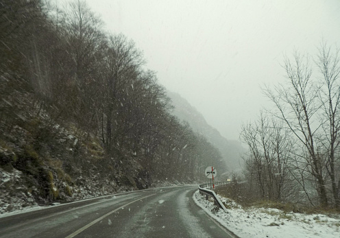 On the mountain road during the snow blizzard