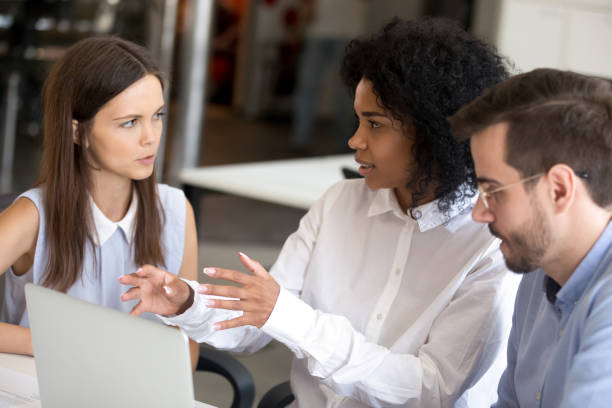 istock Employees discussing online project with African American leader 1092907166
