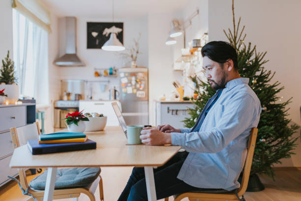 istock Single Japanese man using computer for online Christmas shopping 1092924798