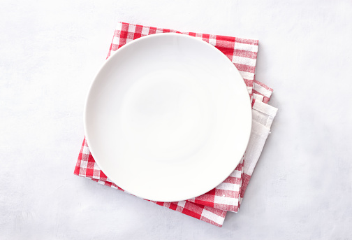 Empty round plate on light gray background. Top view