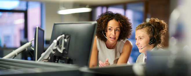 a female call centre worker trains an intern
