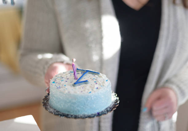istock Mom holding baby’s first birthday cake 1092934020