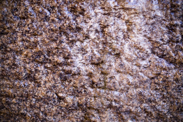 wet beige cave granite wall texture with vignette. background, geological.