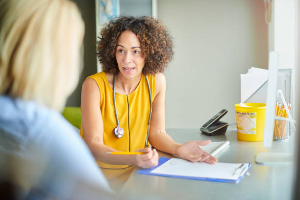 female gp explaining the prognosis happy female doctor with her patient prescription medicine photos stock pictures, royalty-free photos & images