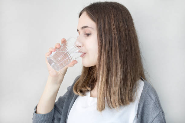 istock Young woman drinking water 1092951368