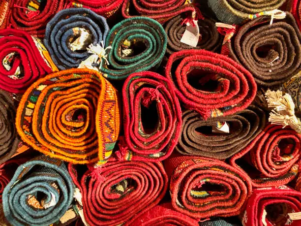 Many wool carpets are rolled up and waiting to be sold in a rug store in Fes, Morocco.