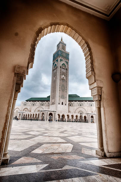 King Hassan II Mosque Through Arch A view of the King Hassan II Mosque in Casablanca, Morocco as seen through an arch. casablanca stock pictures, royalty-free photos & images