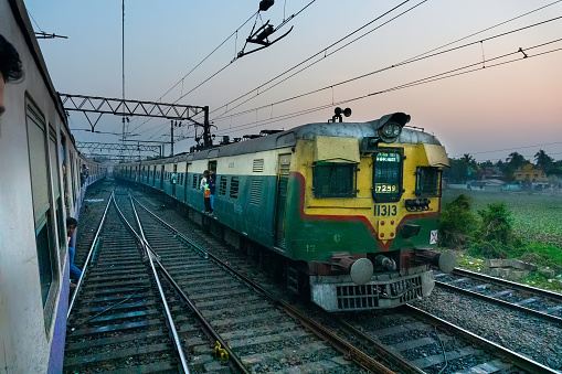 HOWRAH STATION , HOWRAH, WEST BENGAL / INDIA - 4TH FEBRUARY 2018 : A passenger train passing through railway track in late afternoon.