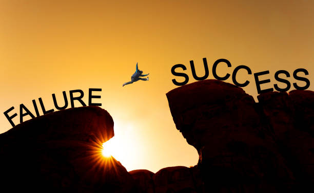 istock Silhouette a man jumping over precipice from failure to success.Business success, challenge, achievement and leadership concept 1092999532