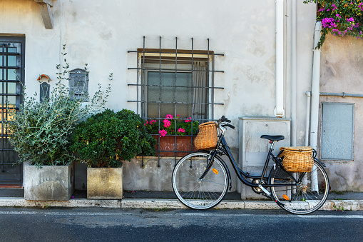 Bicycle with wicker baskets on the street in Orbetello on peninsula in Argentario in Tuscany. Italy