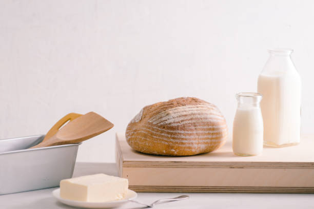 istock Bread bake and butter on wooden cutting board. Simple breakfast 1093013622