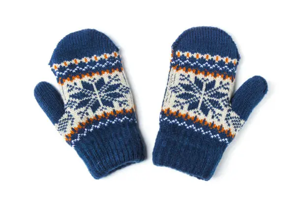 Children's woolen patterned knitted mittens isolated on white