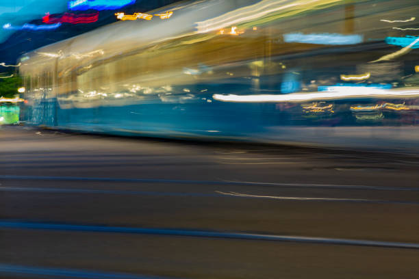 istock Light and traffic at night, long exposure and soft focus. Blurry beautiful urban district background, with tram on tract moving. 1093059434