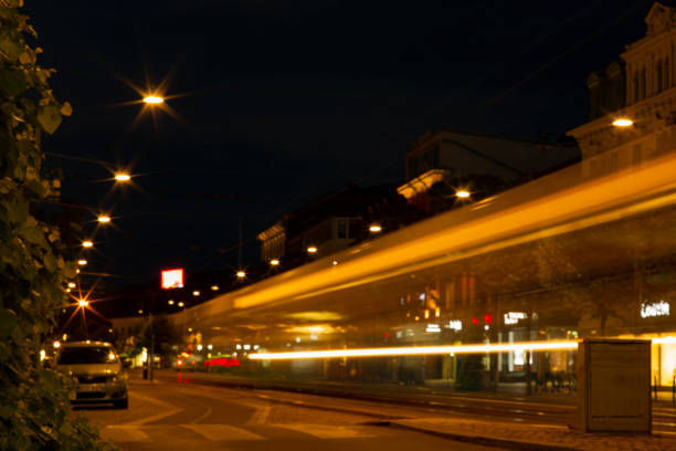 istock Light and traffic at night, long exposure and soft focus. Blurry beautiful urban district background, with tram on tract moving. 1093060474