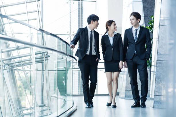 istock business partners walking down in office building and discussing work 1093063200
