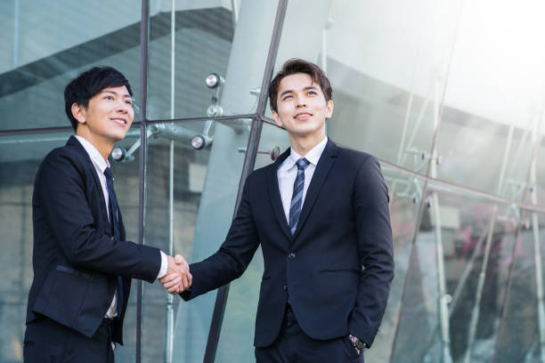 istock Two confident businessmen shaking hands and smiling 1093063612
