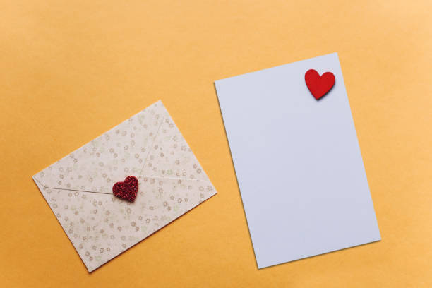 istock Blank sheet with red heart for text or write. Near an envelope with a heart to send. 1093067484