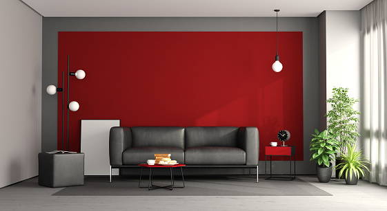 Living room with black sofa against red wall - 3d rendering
Note: the room does not exist in reality, Property model is not necessary
