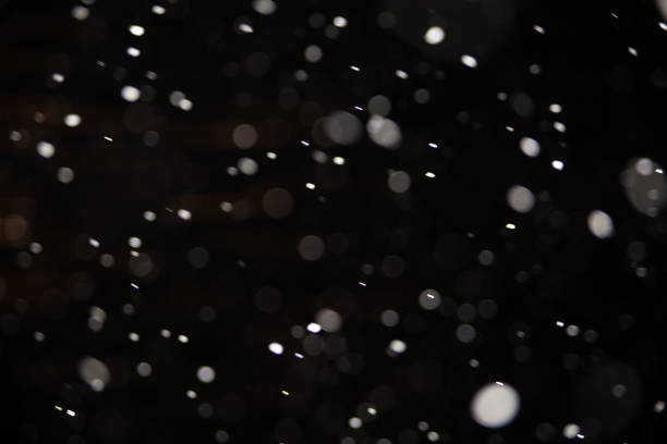 istock Background of falling snowflakes in the light of a lantern. 1093076314