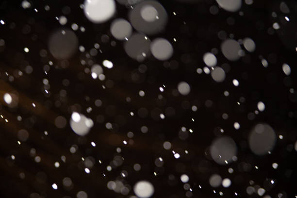 istock Background of falling snowflakes in the light of a lantern. 1093076356