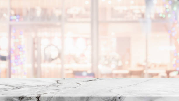 istock Empty white marble stone table top on blurred with bokeh shopping mall and restaurent interior background - can be used for display or montage your products 1093084126