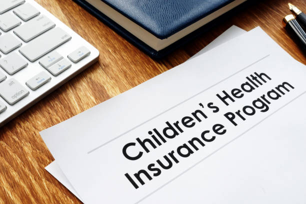 istock Childrens Health Insurance Program CHIP documents on a desk. 1093085652