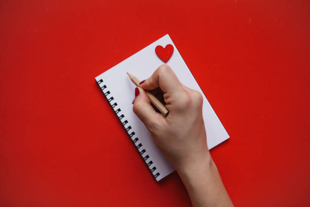 istock The girl writes congratulations or something else in a notebook. 1093086394