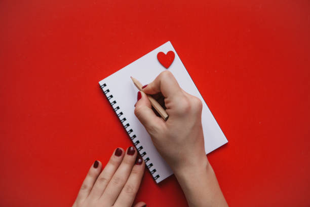 istock The girl writes congratulations or something else in a notebook. 1093086396
