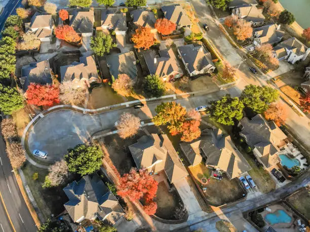 Aerial view lakefront neighborhood with cul-de-sac (dead-end) street near Dallas, Texas. Morning autumn season with colorful fall foliage leaves