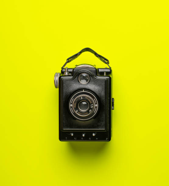 istock black old camera genos on green yellow background isolated from above 1093091950
