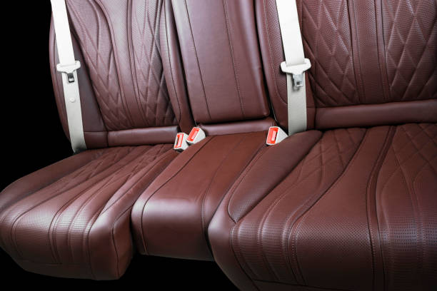 istock Brown leather interior of a car. Perforated Leather comfortable seats with stitching isolated on black background. Car interior details. Car detailing. Car inside 1093092930
