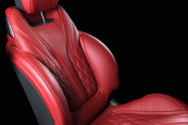istock Red leather interior of a car. Perforated Leather comfortable seats with stitching isolated on black background. Car interior details. Car detailing. Car inside 1093093204