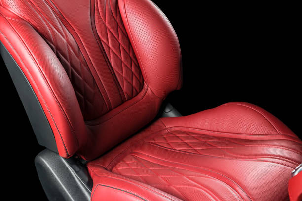 istock Red leather interior of a car. Perforated Leather comfortable seats with stitching isolated on black background. Car interior details. Car detailing. Car inside 1093093542