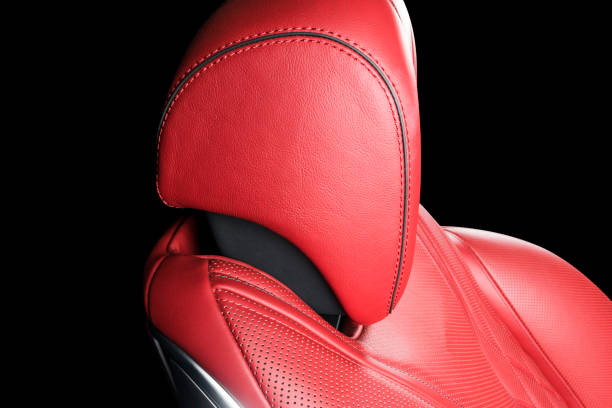 istock Red leather interior of a car. Perforated Leather comfortable seats with stitching isolated on black background. Car interior details. Car detailing. Car inside 1093093600