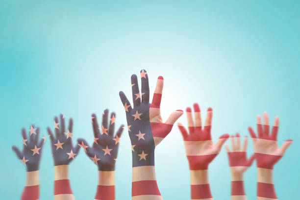 American flag pattern on people's hand group raising up group