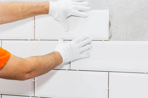 istock laying tiles on the wall with gaskets, repair work 1093096946